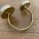 Gold hoop earrings on a wooden surface