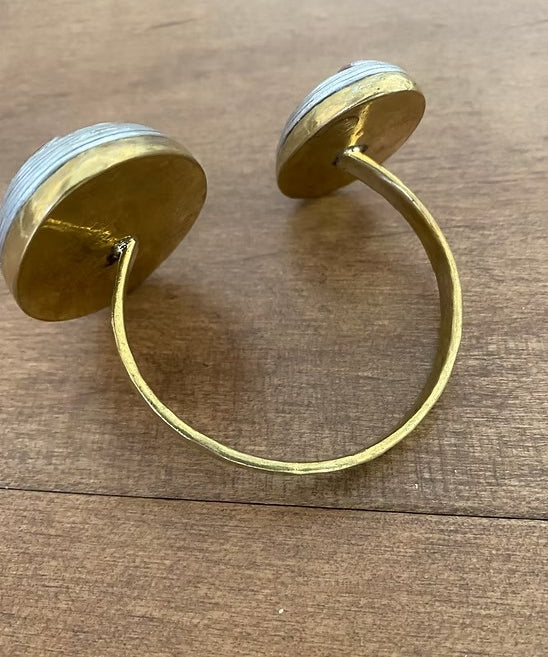 Gold hoop earrings on a wooden surface