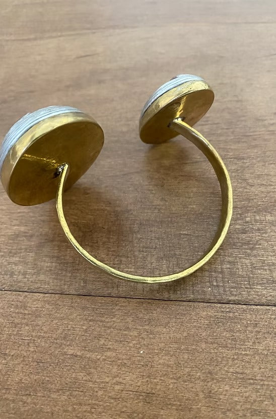Gold hoop earrings on a wooden surface