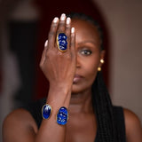 Woman wearing blue rings on her fingers with a blurred background