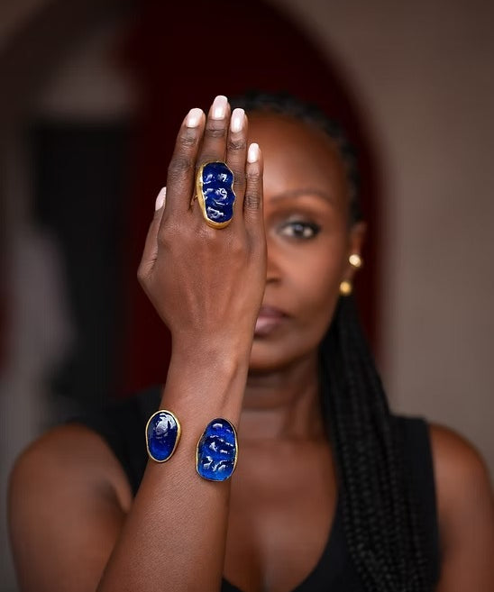 Woman wearing blue rings on her fingers with a blurred background