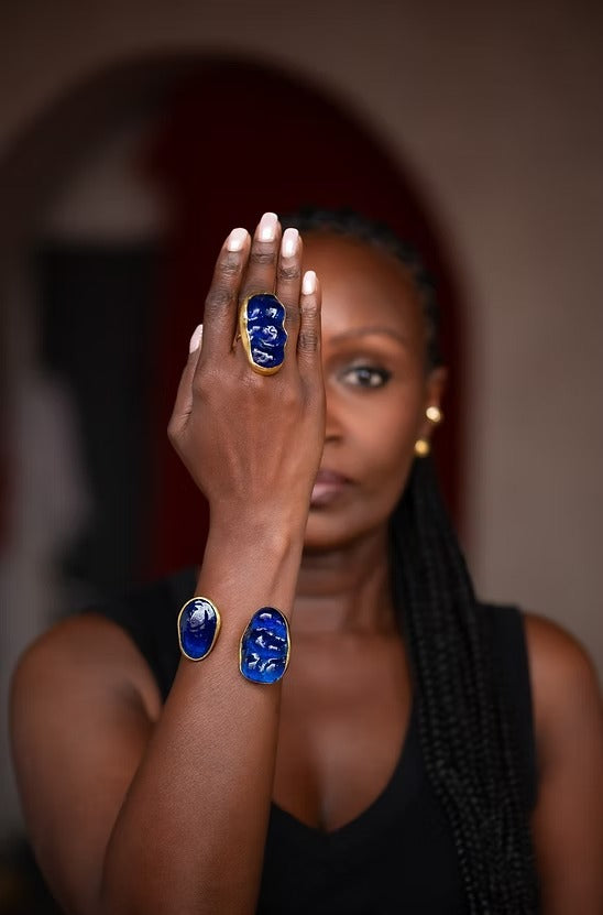 Woman wearing blue rings on her fingers with a blurred background