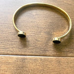 Gold bracelet on a wooden surface