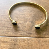 Gold bracelet on a wooden surface